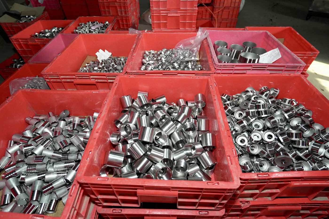 Finished stainless camlock fittings organized for inspection